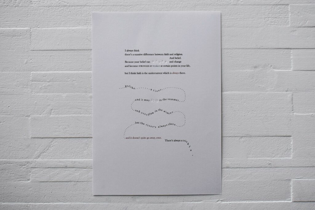 A3 print of concrete poetry with black, red and inklessly debossed words against a white brick background