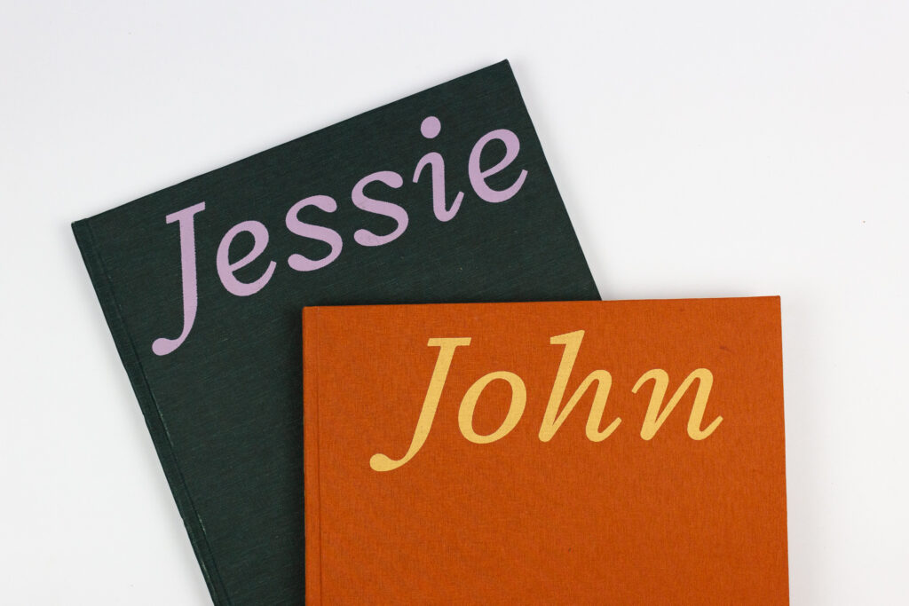two book covers, on green and orange book cloth, with serif italic type that reads 'John' and 'Jessie'.